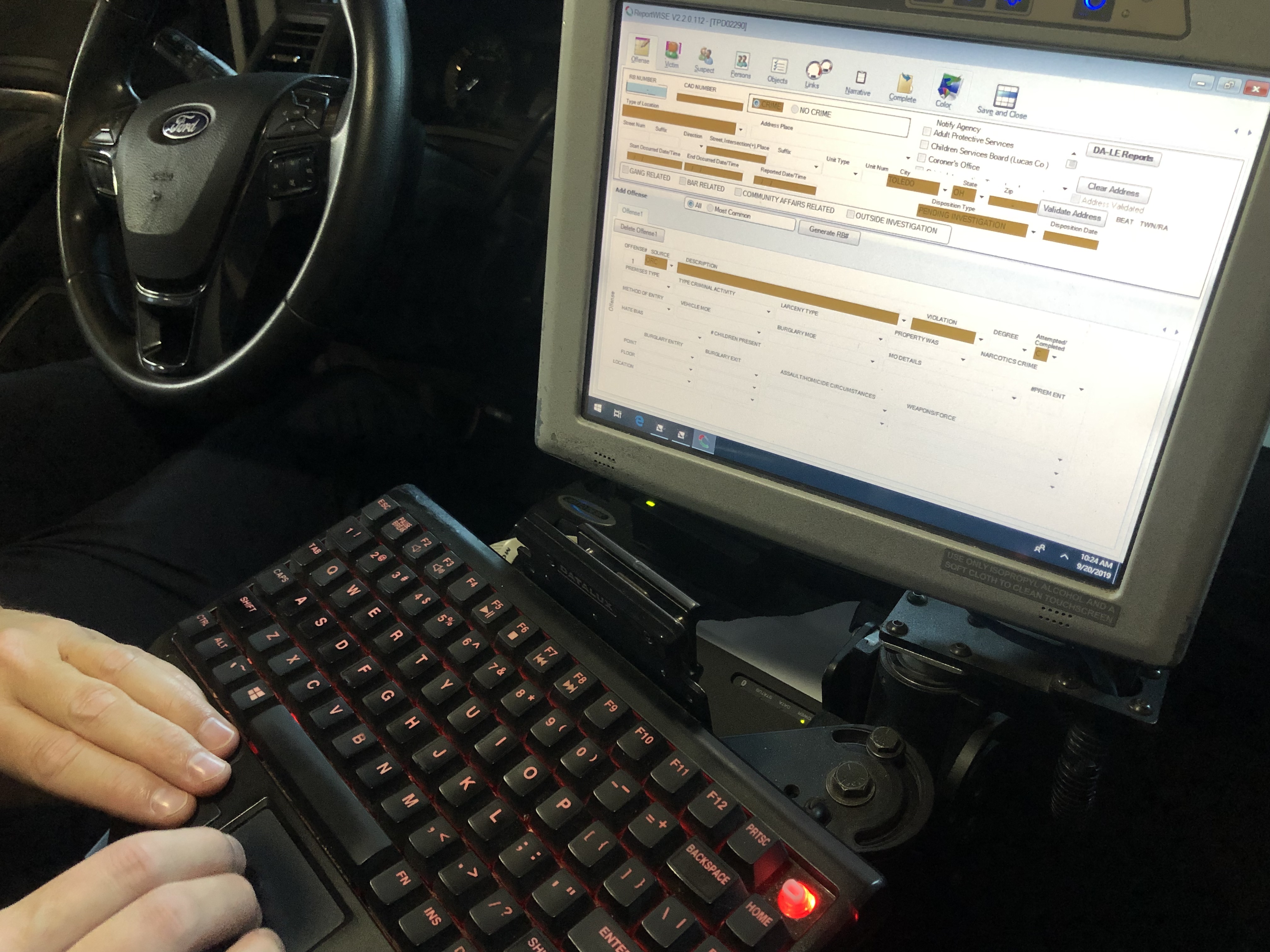 A police officer filing a citation on their car’s computer